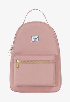 Ljusrosa ryggsäck i kanvas. Rundad form med en framficka med dragkedja. Har ett vitt logomärke och guldfärgad dragkedja.