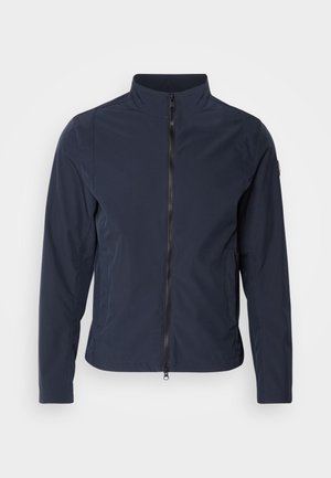 Casaco leve azul marinho com gola alta, fecho de correr de comprimento total, bolsos laterais e textura suave e macia. Design simples e minimalista.