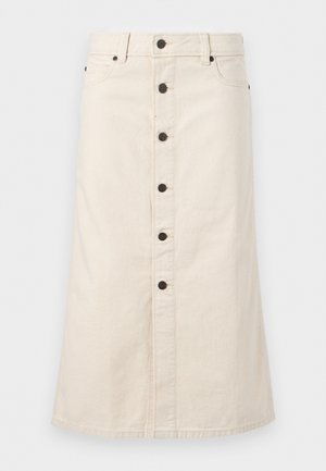 Beež värvi põlveni ulatuv teksaseelik, esiküljel mustade nuppude, vööaasade ja küljetaskutega, valgel taustal.