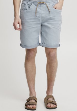 Light blue denim shorts with rolled cuffs, featuring an adjustable drawstring waistband, two side pockets, and a relaxed fit.