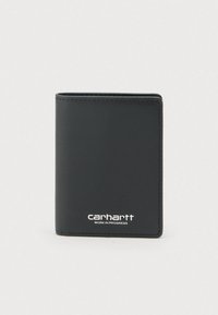 Μαύρο δίπτυχο δερμάτινο πορτοφόλι με το λογότυπο Carhartt Work in Progress χαραγμένο σε λευκό στην μπροστινή πλευρά, σε απλό φωτεινό φόντο.