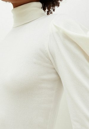 Crème col roulé trui in lichte stof, met een aansluitende pasvorm en puff mouwen, met een ribbeltextuur en een gladde afwerking.
