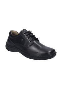 Chaussure habillée en cuir noir avec un bout rond, fermeture à lacets, et détails de couture autour de la semelle. Fini lisse et intérieur rembourré.