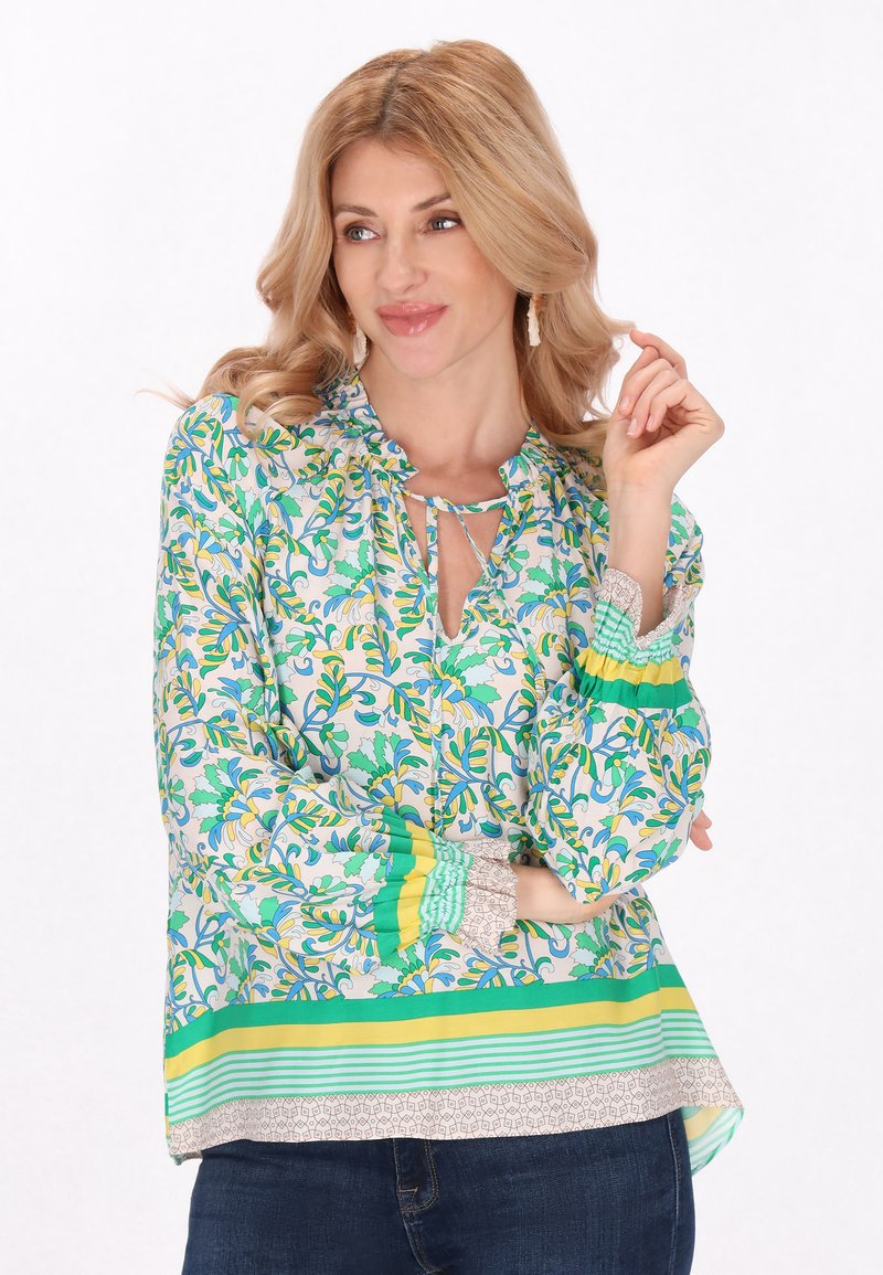 Blusa floreale in tessuto leggero, con motivi verdi e gialli, scollatura a chiave e maniche a righe a contrasto con orlo.
