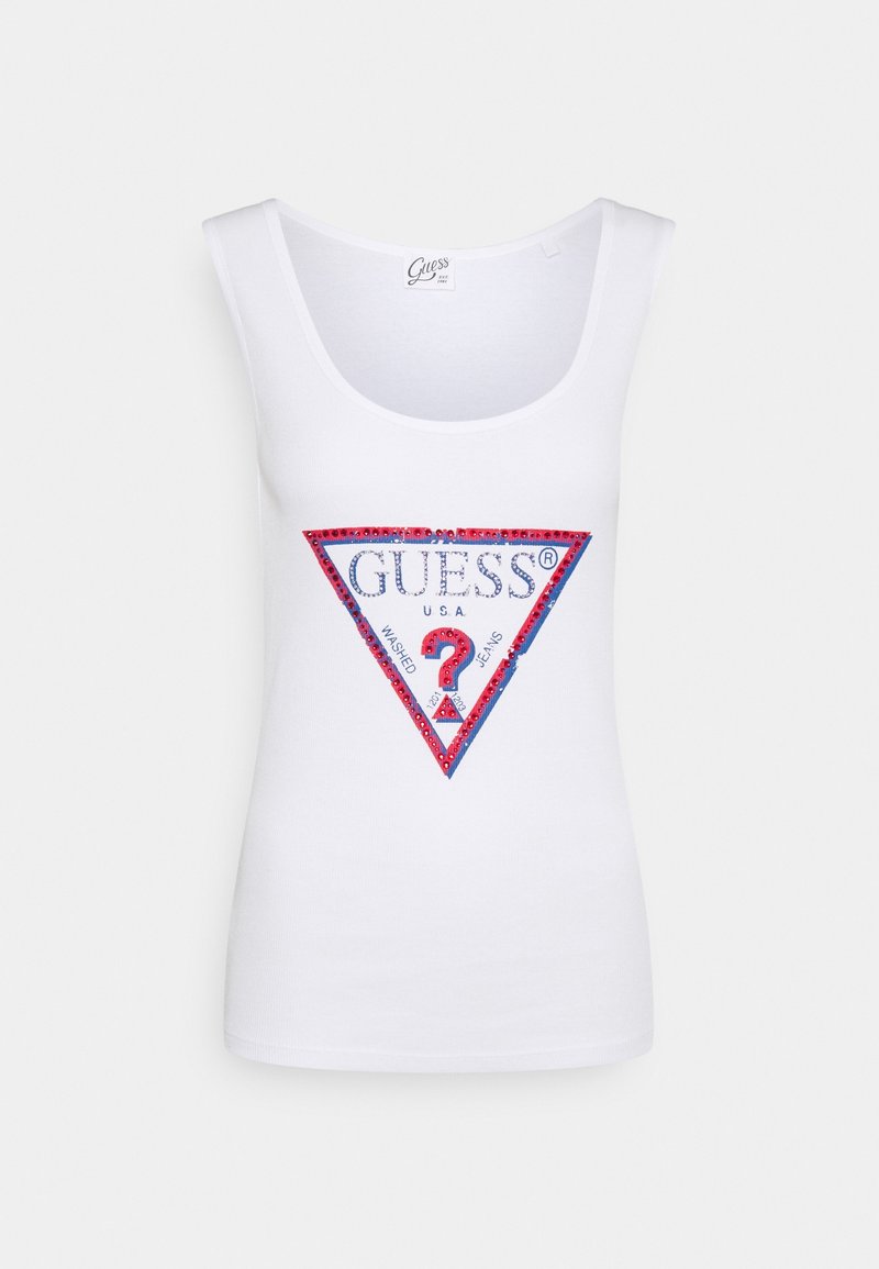Débardeur blanc avec un col dégagé, ornée d'un logo triangulaire rouge et bleu avec des accents en strass, portant l'inscription "GUESS USA WASHED JEANS".