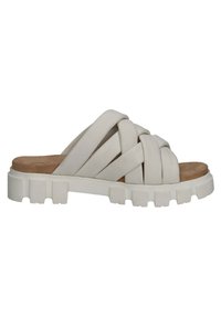 White woven slide sandals featuring a chunky rubber sole and a textured upper with crossed straps, set against a flat brown insole.