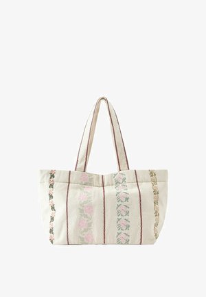 Sac fourre-tout en tissu beige avec des rayures florales verticales en rose, vert et marron, et deux longues anses avec bords cousus.