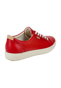 Red leather sneaker with white laces and beige heel tab. Smooth texture and rounded shape with a contrasting sole. Subtle branding detail.