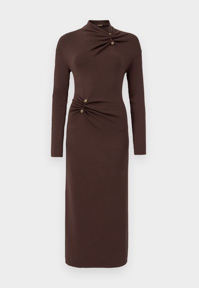 Brown long-sleeve dress featuring a high neckline, twist detail at the waist with two gold buttons, and a fitted, ankle-length design.