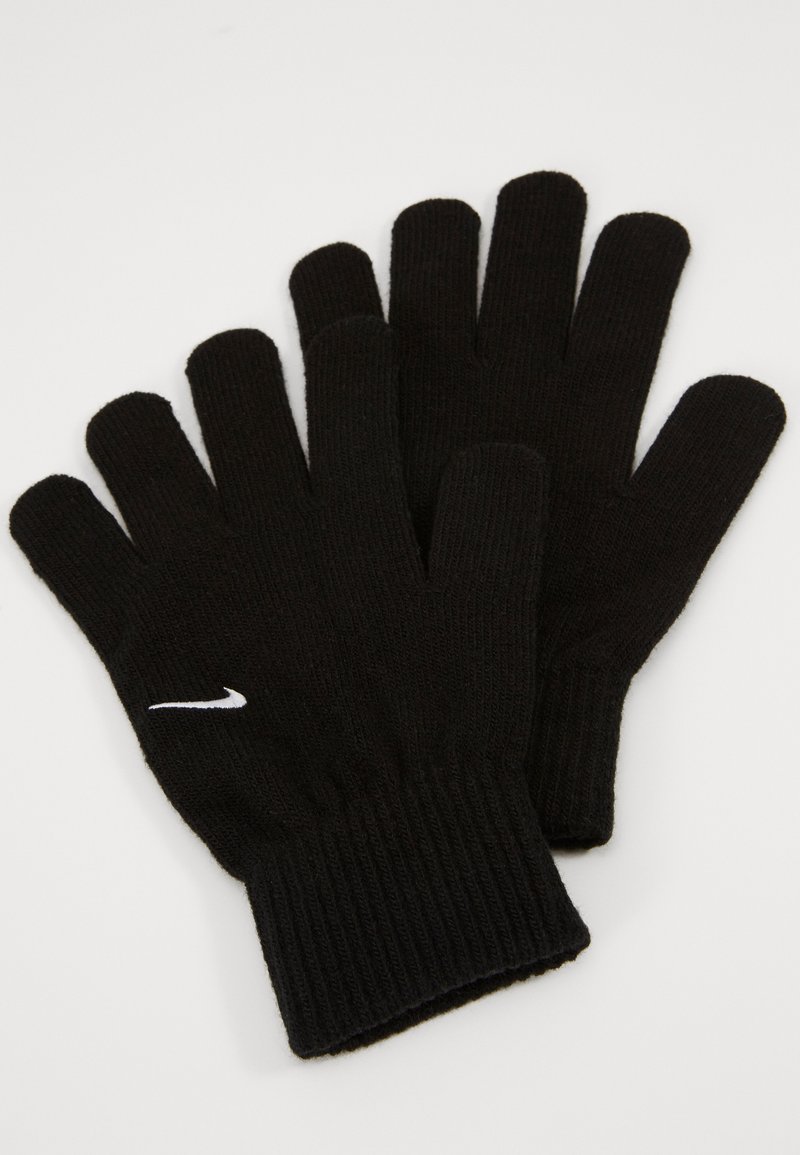 Mustad mustrehakid soonte voodriga, millel on väike valge Nike logo randmel. Sile tekstuur, loodud soojust ja osavust tagama.