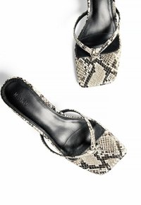 Snake print high-heel sandals with a squared toe, featuring a textured pattern, black straps, and a smooth black insole.