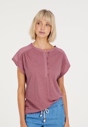 Lichtroze, kort mouwtop met een ronde halslijn en een vijf-knopen voorkant. Zachte stof met een relaxte pasvorm, gecombineerd met casual blauwe shorts.