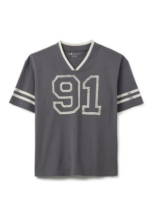 Camiseta gris de manga corta y cuello en V con un acento blanco en el collar y el número "91" impreso desgastado en el frente. Presenta rayas horizontales en las mangas.