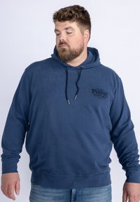 Felpa in cotone blu navy con cappuccio, caratterizzata da una stampa logo frontale, coulisse regolabile e polsini e orlo a coste.