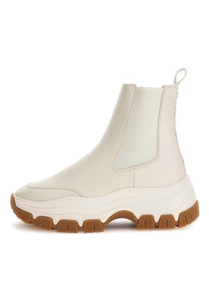 Scarpe ankle beige chiaro con finitura in pelle liscia, pannelli laterali in elastico e suola in gomma spessa con scanalature ben evidenti.