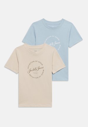 Kaks lühikeste varrukatega ümar kaelusega t-särki, üks beež ja teine hele sinine, mõlemal rinnal ümmargune "Jack & Jones Definition of Denim" logo.