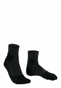 Calze sportive nere con bordo a costine e talloni rinforzati. Presentano un motivo testurizzato sulle suole e un logo discreto vicino alla caviglia.