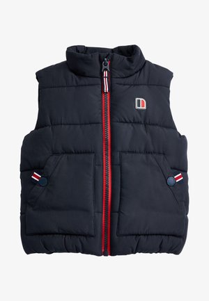 Gilet bleu marine en duvet avec un col montant, fermeture éclair rouge, deux poches avant et accents rayés sur les boutons. Présente un patch logo.