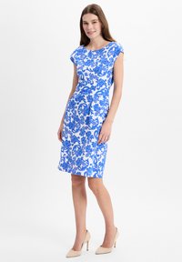 Fitted dress in white featuring a blue floral pattern. Cap sleeves and knee-length design; smooth texture, and no visible hardware.