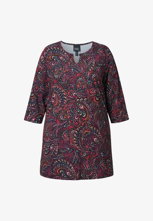 Pitkähihainen tunika, jossa on V-pääntie, ja joka esittelee moniväristä paisley-kuviota mustalla taustalla. Valmistettu sileästä, kevyestä kankaasta.