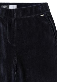 Pantaloni in corduroy blu scuro con una cintura liscia e tasche laterali, caratterizzati da una texture a strisce verticali e un piccolo logo metallico.