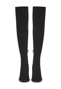 Bottes noires au-dessus du genou avec un tissu extensible, un talon haut et des détails de fermeture éclair sur le côté. Texture lisse avec une finition légèrement brillante.