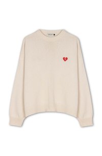 Cream knitted sweater with a round neck, ribbed cuffs, and a red broken heart design on the left chest. Short, relaxed fit.