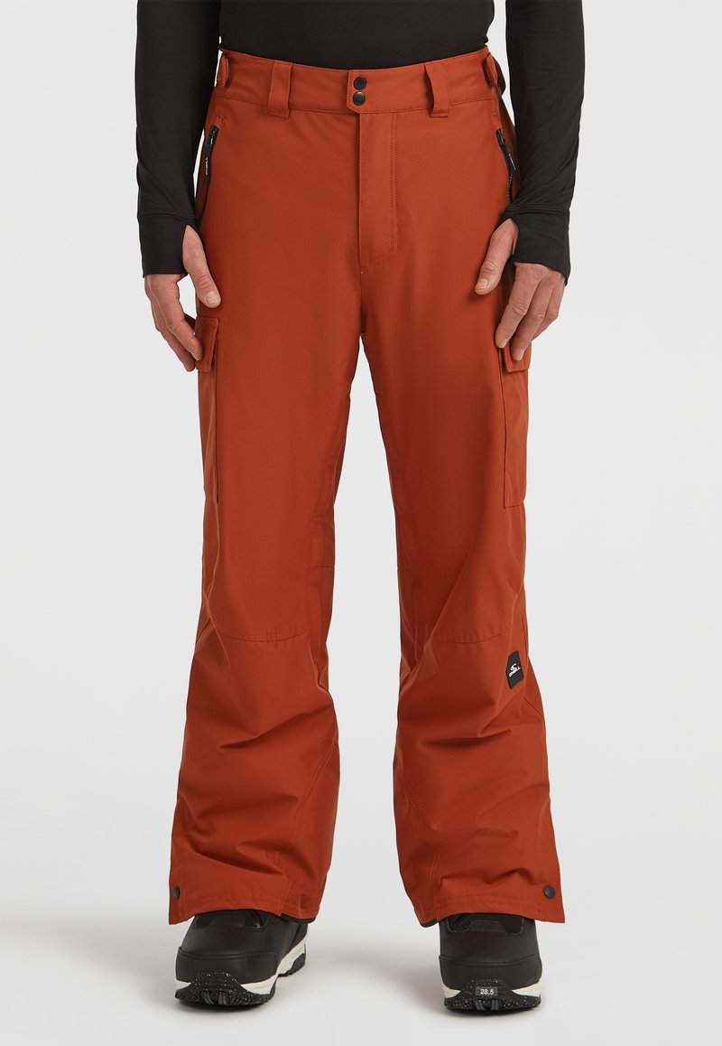 Water-resistant orange snow pants with a straight-leg design, multiple zippered pockets, and reinforced hems, paired with black boots.