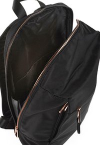 Mochila negra con un gran compartimento abierto, herrajes de cremallera en oro rosa y dos bolsillos exteriores con cremallera. Tejido suave y duradero.