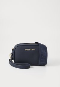 Borsa a tracolla in pelle blu navy con finitura testurizzata, logo dorato e tracolla regolabile con un accentuato motivo. Chiusura con zip nella parte superiore.