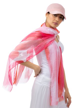 Leichte, durchsichtige Schal mit einem Aquarellmuster in Rosa- und Weißtönen, mit fransenartigen Rändern, der elegant über einem weißen Oberteil drapiert ist.