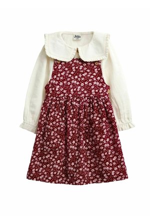 Mädchen langärmeliges weißes Oberteil mit Rüschenkragen unter einem roten ärmellosen Kleid mit kleinem weißem Blumenmuster und Knopfdetails.