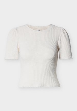 Cream ribbed short-sleeve top with a round neckline, slight puff sleeves, and scalloped hem. Material appears textured and lightweight.