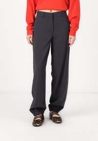 Gray, wide-leg pants with a smooth texture and a tailored fit. Features a flat front, belt loops, and elastic cuffs at the ankles.