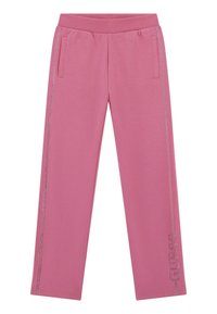 Pantalons de survêtement en coton rose avec une taille côtelée, des poches latérales et des embellissements métalliques sur la jambe gauche affichant le nom de la marque "GUESS."