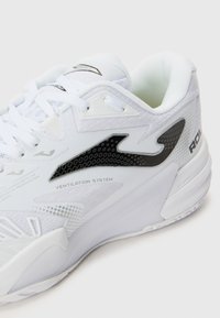 White athletic shoe with ventilation system detail, featuring a textured upper, black accent logo, and a textured sole design.