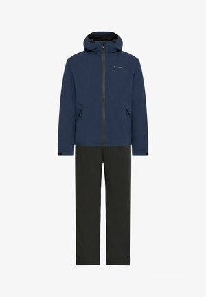 Navy waterproof jacket with a hood, front zipper, and side pockets, paired with black waterproof pants featuring adjustable cuffs.