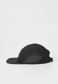 Black cap with a curved brim, made of lightweight fabric. Features a perforated design on the side for ventilation and an adjustable strap.