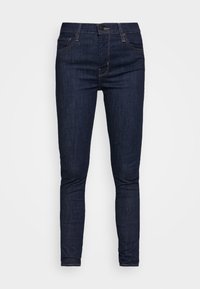 Mörkblå skinny jeans i denim med en klassisk femfickdesign, framknäppning och kontrasterande sömmar.