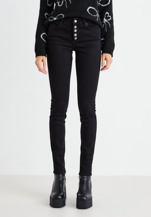 Zwarte skinny jeans met een hoge taille, vijfknops sluiting en klassieke achterzakken. Gemaakt van rekbare denim stof.