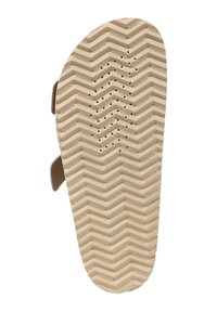 Sole di scarpa in gomma color beige con un motivo a zigzag, dotata di fori di ventilazione e scritte del marchio. Le cinghie sui lati indicano un design tipo sandalo.