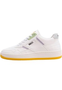 White sneaker with textured leather, yellow rubber sole, green and purple accents, and a logo on the side. Rounded toe and lace-up design.