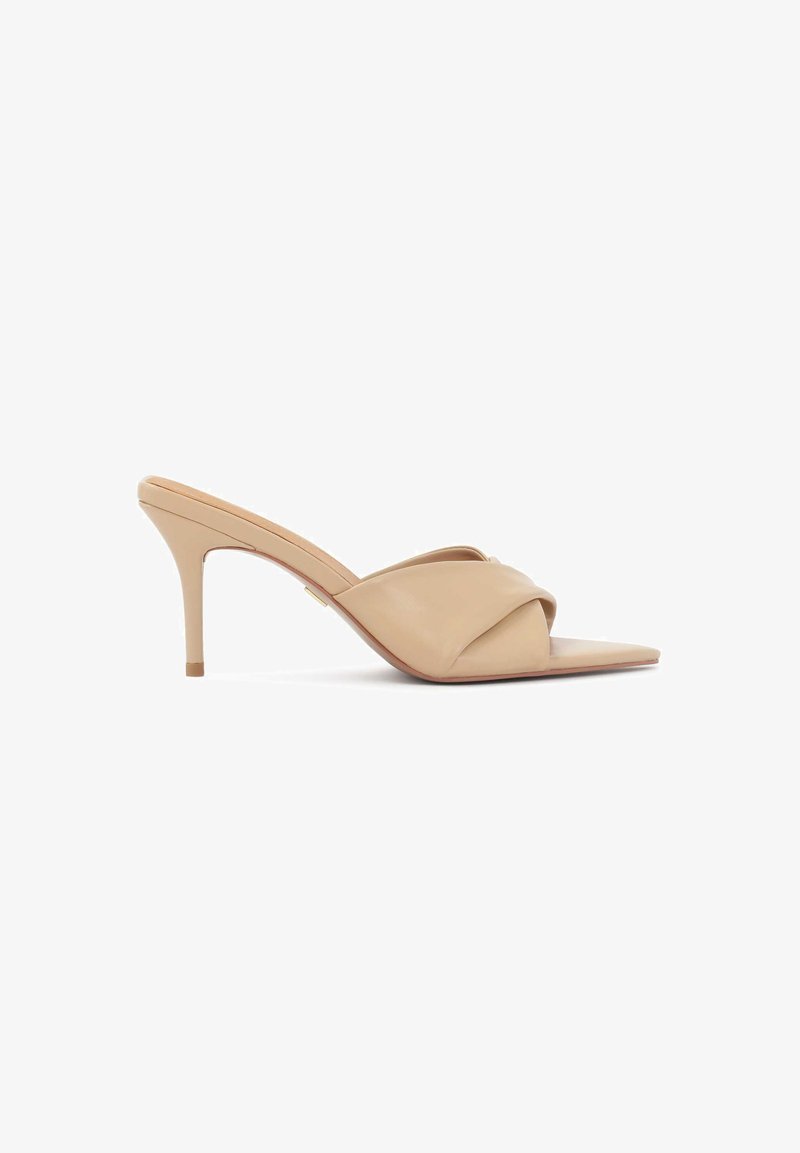 Beige high-heel mules with a pointed toe, smooth leather material, and crossed strap design. Slim stiletto heel enhances elegance.
