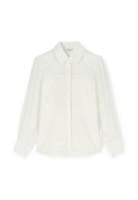 Blouse blanche à manches longues avec col pointu, boutons avant dissimulés et manches à poignets, posée à plat sur un fond blanc.