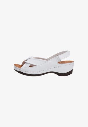 White leather wedge sandals with a cross-over strap design, open toe, and a cushioned insole. Features a contrasting brown sole.