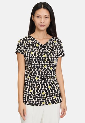 Short-sleeve top in a lightweight fabric featuring a cowl neckline, black, olive, and cream abstract print, with a fitted silhouette.
