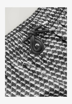 Shorts de baie alb-negru cu un model în zigzag, talie elastică și șnur cu vârfuri din metal argintiu. Material neted și ușor.