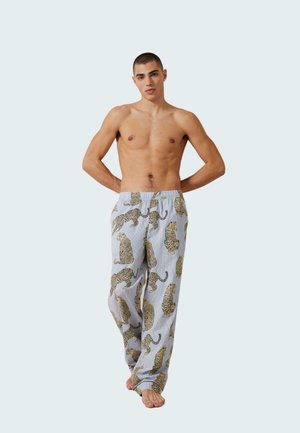 Pantalones de pijama azul claro con un patrón de leopardo en beige y negro. Fabricados con un tejido suave y con una cinturilla elástica.