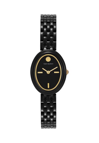 Montre-bracelet ovale noire avec des accents dorés, bracelet à maillons, et cadran minimaliste affichant le logo Tory Burch et l'heure 10:12.