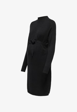 Svart strikket graviditetkjole med ribbet høy hals, lange ermer og et frontbånd i midjen, med en glatt tekstur.